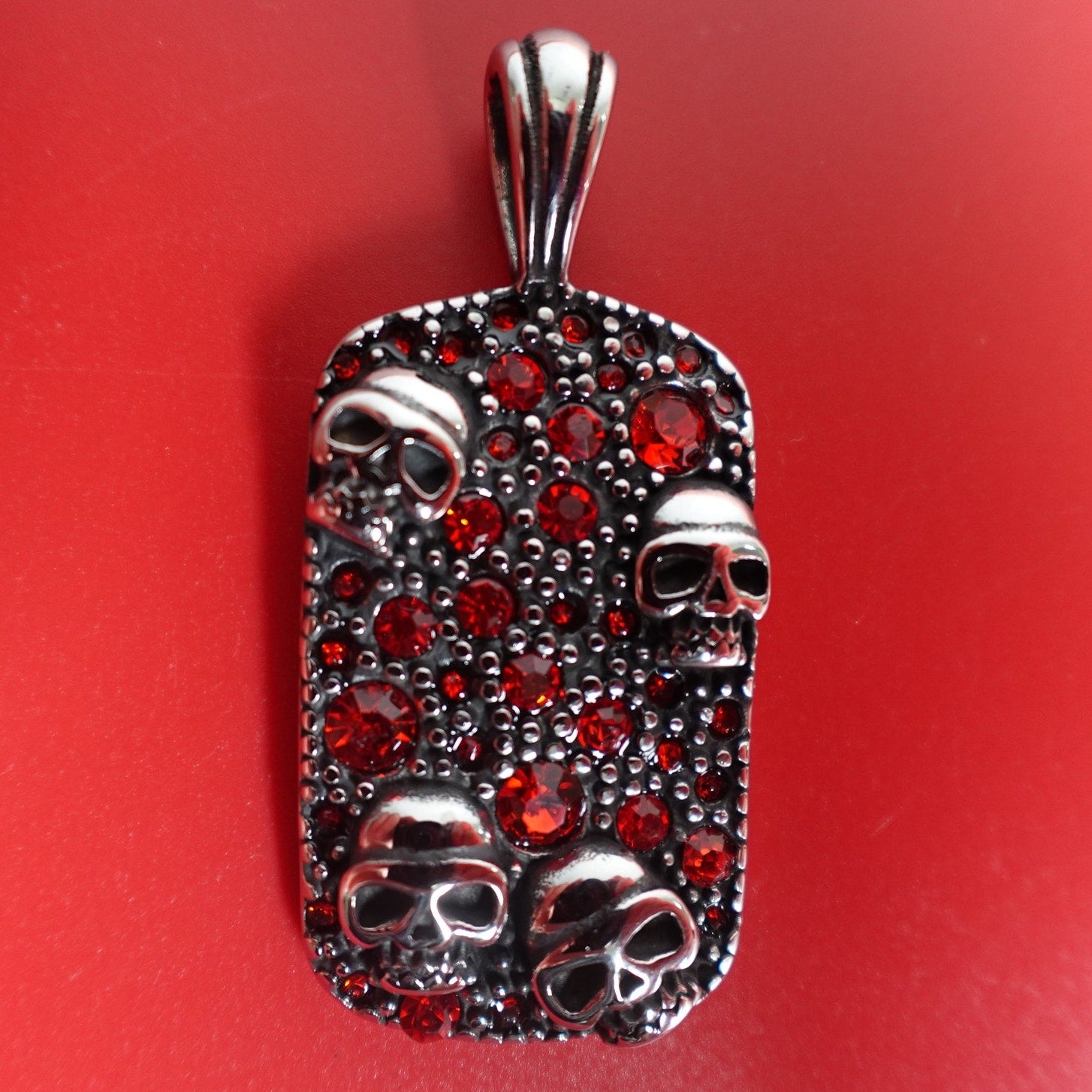 Stainless Steel Red Cubic Zirconia Encrusted Dog Tag with Skulls SP-1810